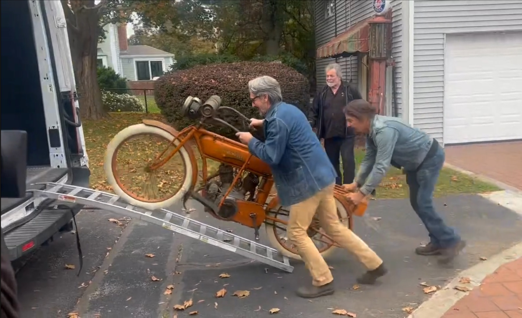 Mike wolfe and Jersey John load the 1915 Flying Merkel twin into their van.
